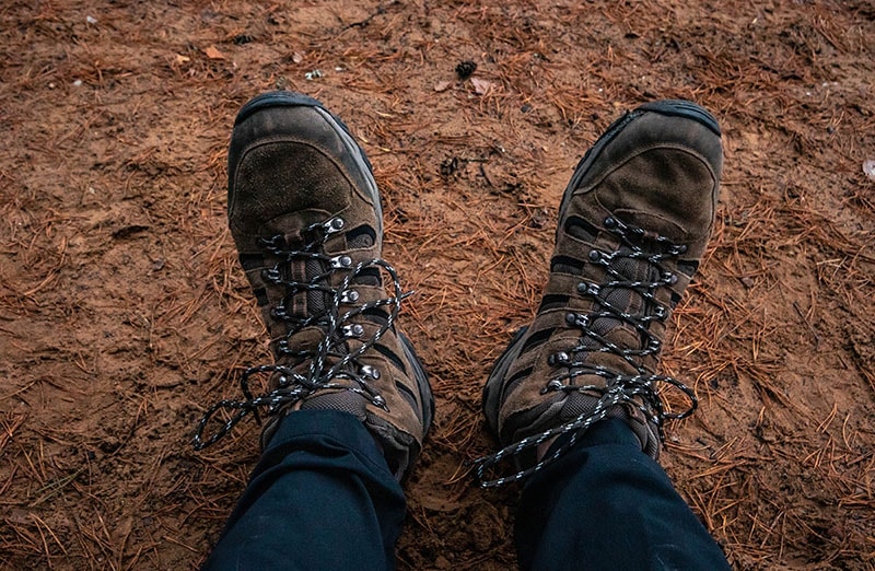 A hiker wearing hiking boots close-up first person view