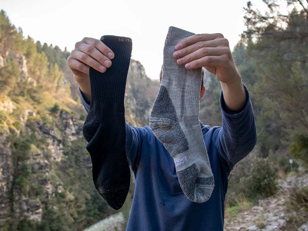 Holding polyester and merino wool socks in hands