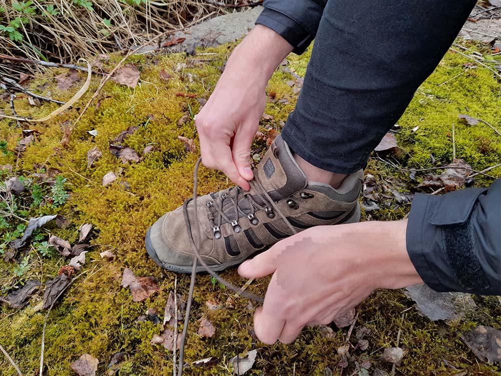 A hiker lacing hiking boots for narrow feet