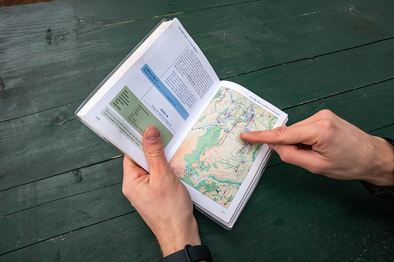 Navigating while hiking with a paper guidebook map