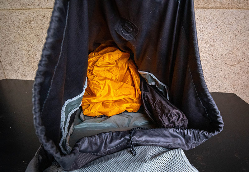packing a tent inside the backpack disassembled