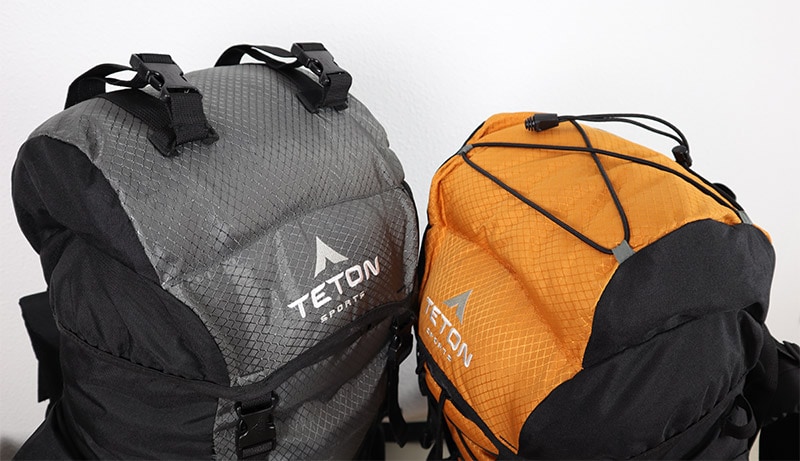 Showing the drawstrings and the buckle straps on top of both Teton Sports backpacks