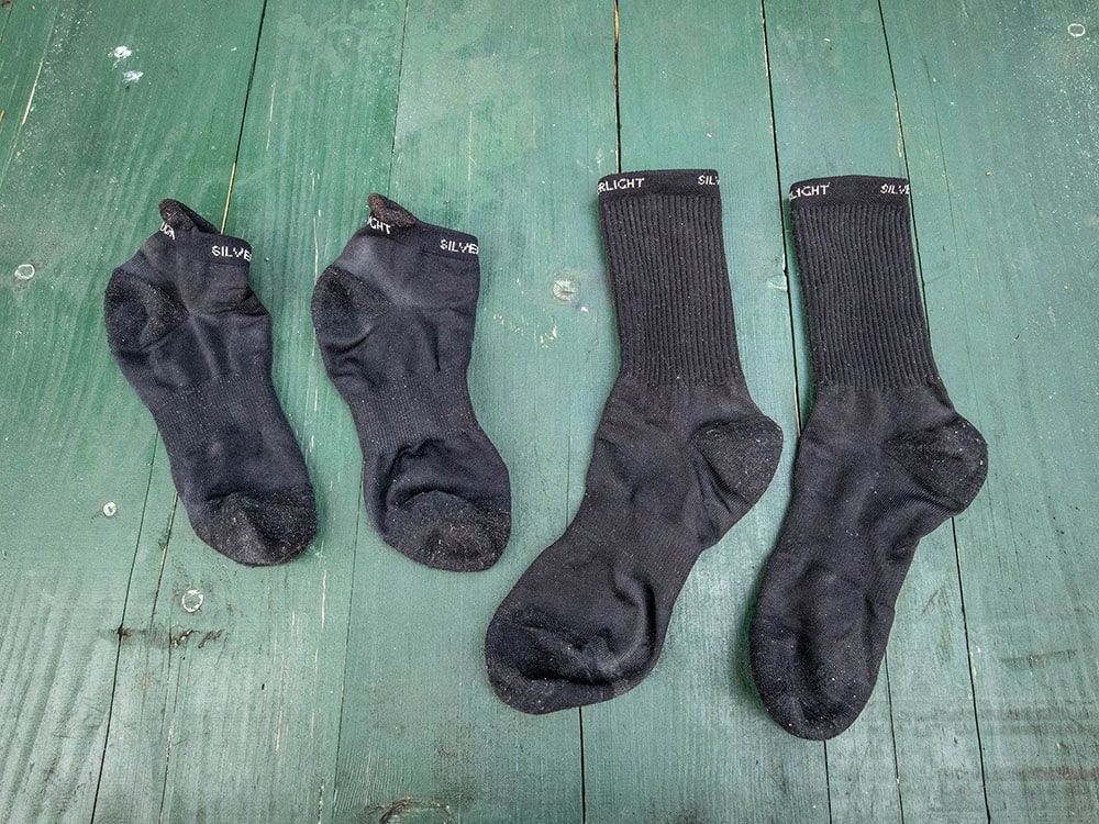 Silverlight hiking socks crew and ankle laid out on a table