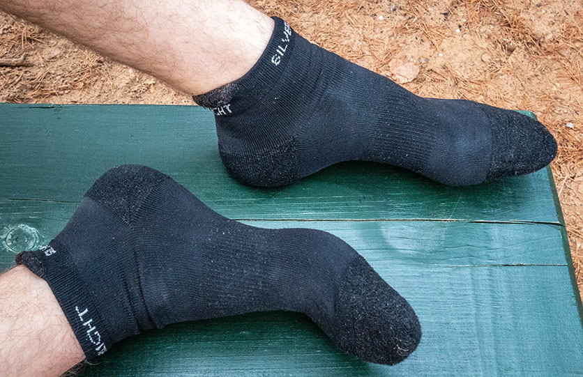 Showing the ankle, short silverlight hiking socks worn on feet