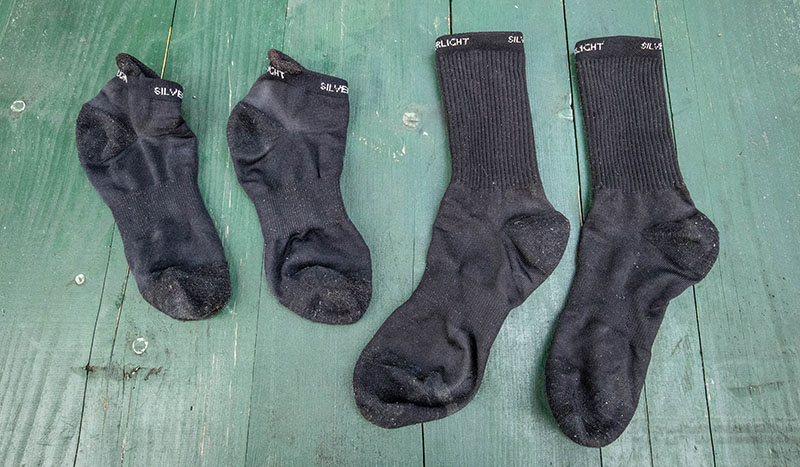 Two pairs of hiking socks laid out on a table