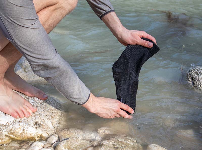 Washing hiking socks in a river
