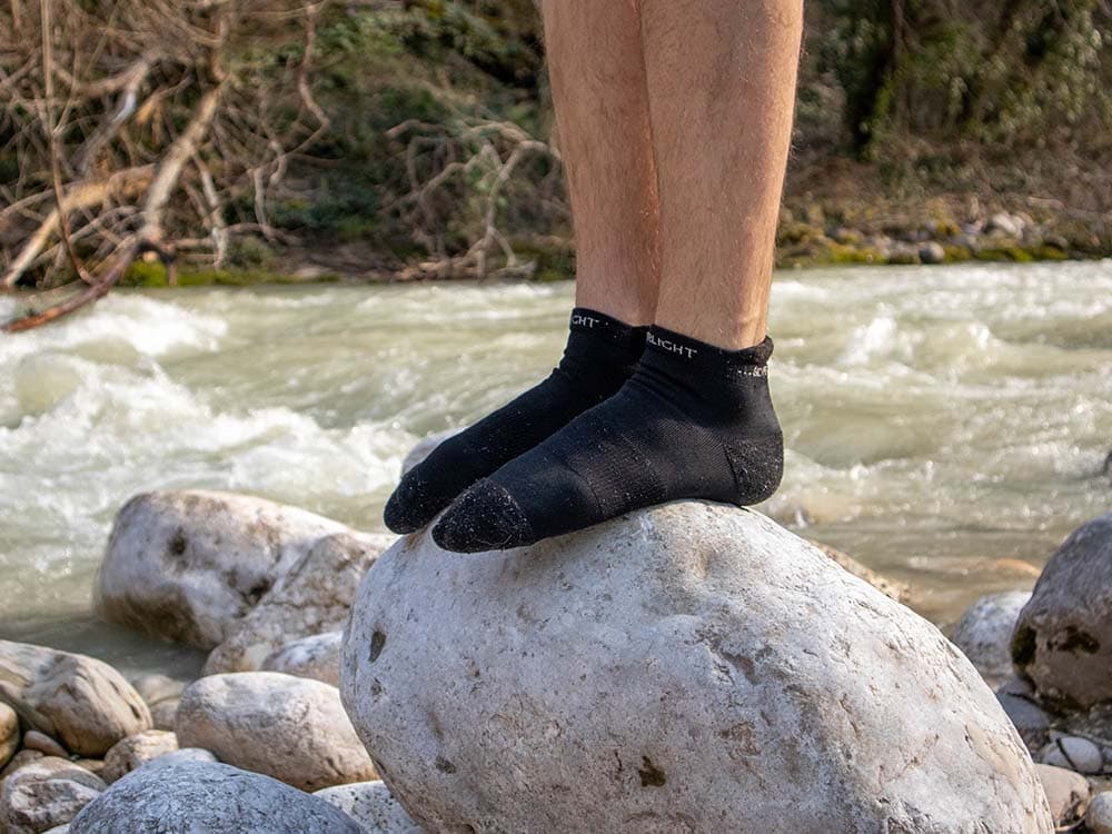 Wearing Silverlight ankle merino wool hiking socks near a river